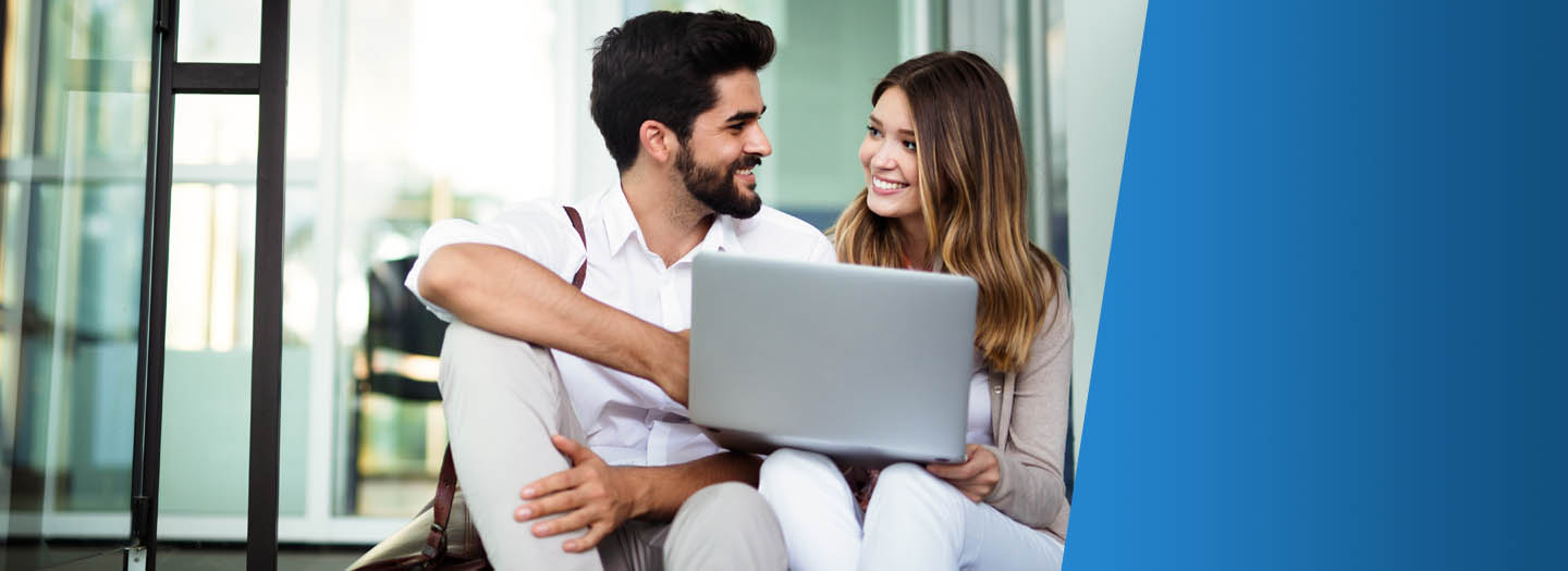 Couple sitting together with laptop